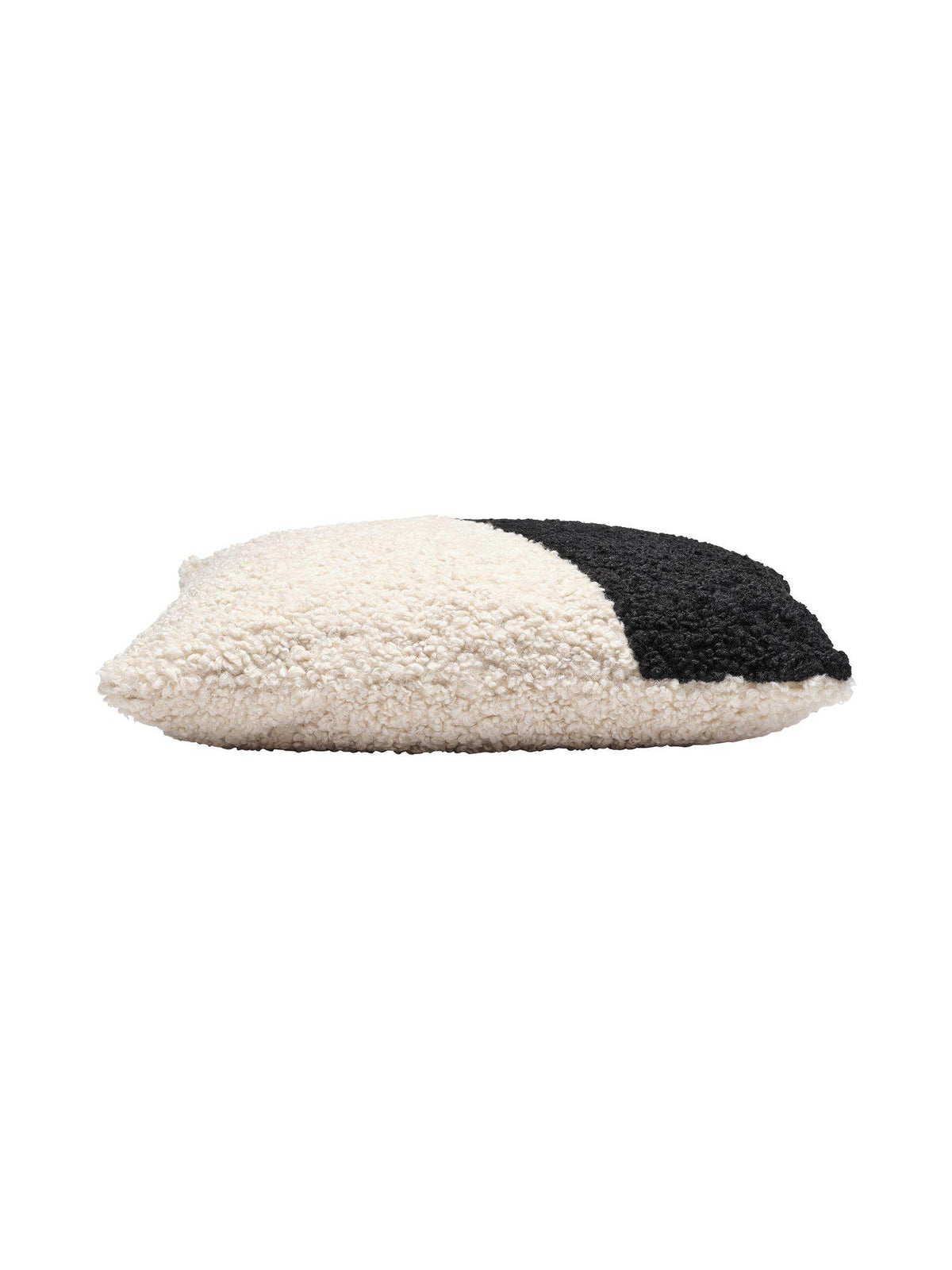 Närbild på strukturen av Teddy kuddfodral i svart och vit ullig textil