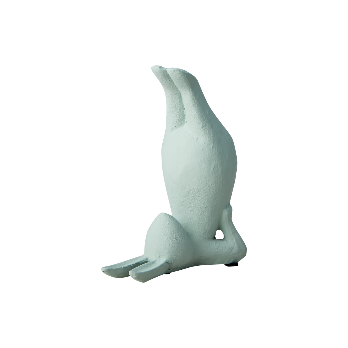 Grön Yoga Kanin i en uppochnervänd yogaposition sedd från sidan