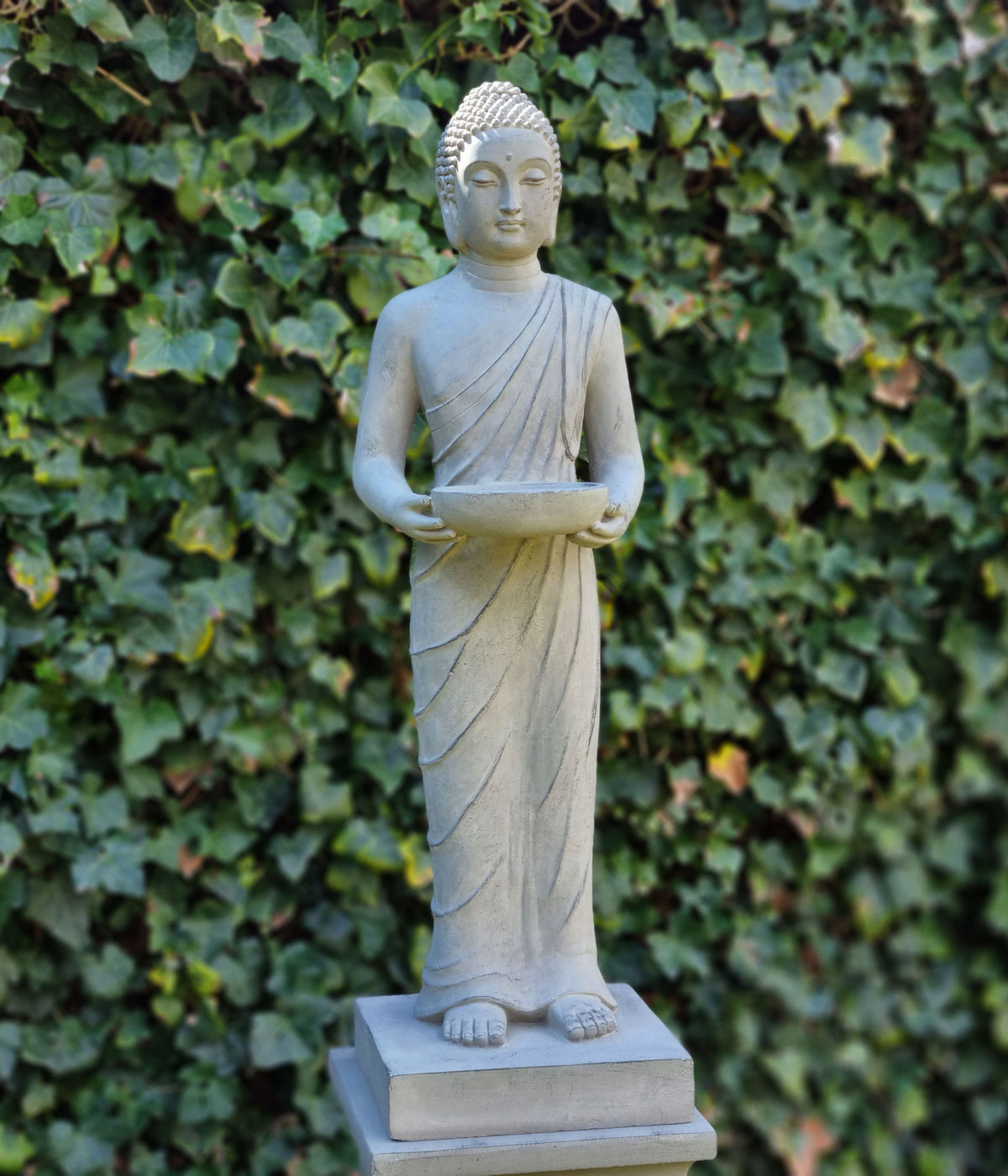Närbild på ansiktet av en Buddha-staty för trädgård med fridfullt uttryck