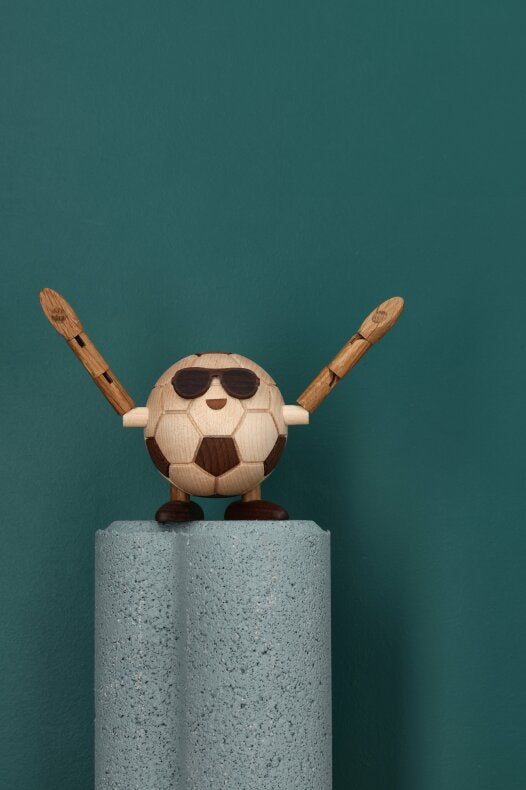 Billy Ball träfigur med solglasögon placerad på en grå pelare